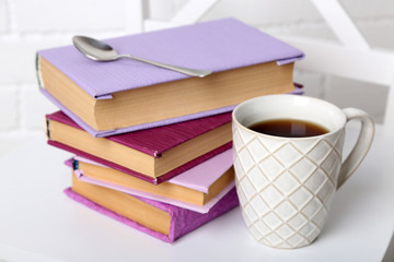 Pile of books with cup and spoon