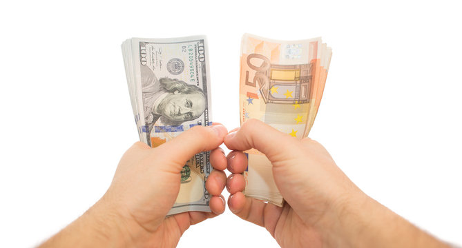 two hands holding dollars and euros isolated