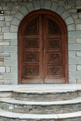 Fototapeta na wymiar large wooden carved arched Church Doors 