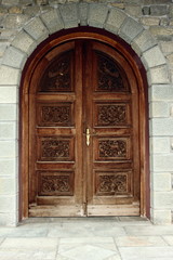 Fototapeta na wymiar large wooden carved arched Church Doors 