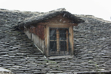 Fototapeta na wymiar slate Roof tiles and old dormer Window