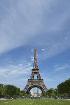 Eiffel Tower with Green Grass and Blue Sky