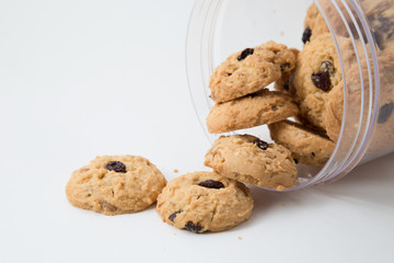 oatmeal raisin cookies spilling out of a jar