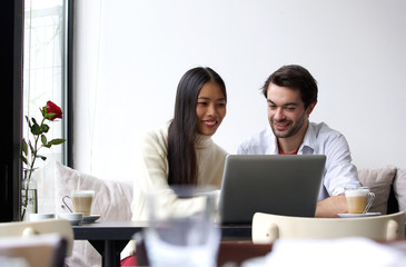 Young man and woman working on laptop