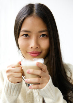 Beautiful young asian woman smiling with cup of coffee