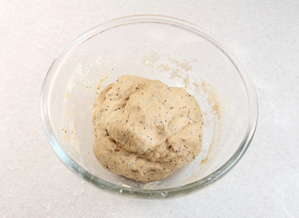 Fototapeta na wymiar Freshly kneaded bread dough in a glass bowl