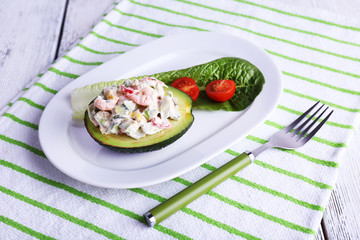 Tasty salad in avocado on plate table close-up