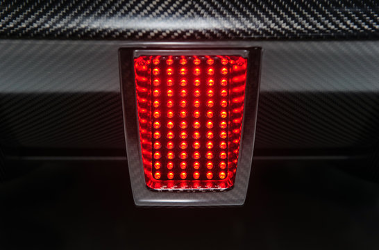 Rear Light Of Powerful Sport Car. Active Red Stop Signal.