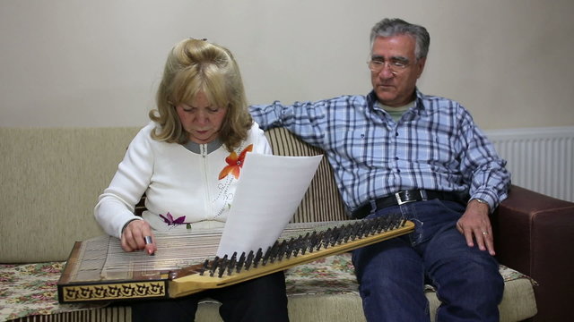 Senior woman playing qanun instrument