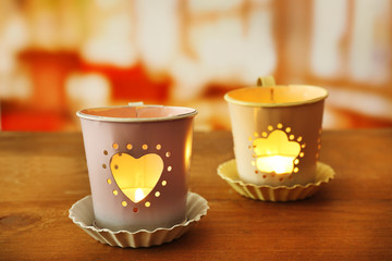 Tow lanterns on wooden surface and blurred background