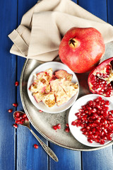 Juicy ripe pomegranates on wooden table