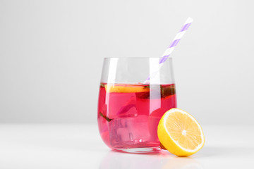 Pink lemonade in glass isolated on white