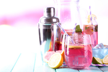 Pink lemonade in glasses and pitcher on table close-up
