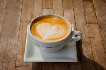 cup of cappucchino over wooden table