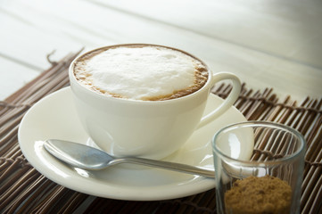 Cappuccino coffee cup with brown sugar.