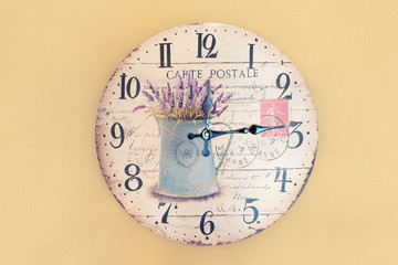 Wall clock in the form of an old postcard