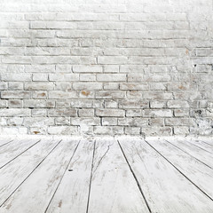 Room interior with white brick wall and wood floor
