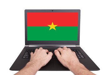 Hands working on laptop, Burkina Faso