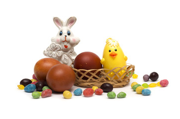 Happy Easter. Rabbit with Easter eggs and candies.