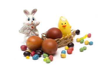 Happy Easter. Rabbit with Easter eggs and candies.