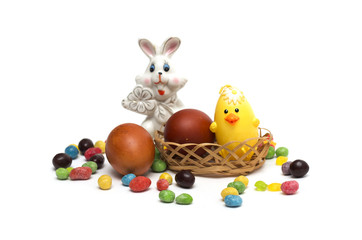 Happy Easter. Rabbit with Easter eggs and candies.