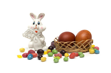 Happy Easter. Rabbit with Easter eggs and candies.