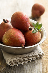 Red pears in metal bowl