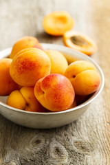 Fresh apricots on metal bowl