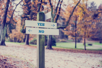 Rustic wooden sign with the words Yes - No