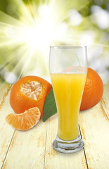 image of juice and tangerine on the table closeup