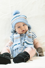 Cute baby boy wearing of warm knitted hat , gloves , Ugg boots