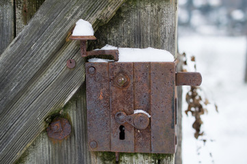 Old lock with snow in the winter