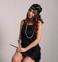 Young sexy girl posing in flapper style dress