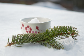 Obraz na płótnie Canvas Winter mug in snow with pine