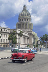 Fototapeta na wymiar Red american car in front of Capitolio, Havana, Cuba