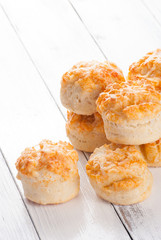 Home made cheese scones on white wood background