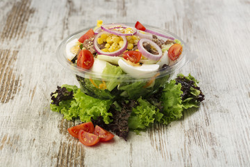 Fresh prepared salad in a bowl to take