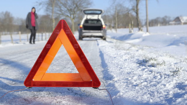 Winter Driving - Car Trouble - Woman calling roadside assistance
