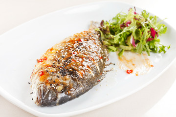 fried fish with fresh herbs and lemon