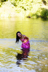 Fototapeta premium Smiling Wet Japanese Woman Wearing Dress In River