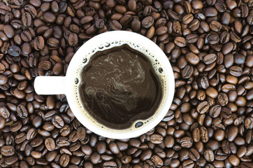 A cup of coffee with coffee bean background