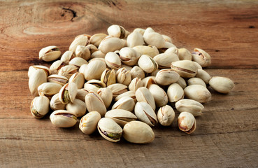Pistachio nuts, close up on wooden table