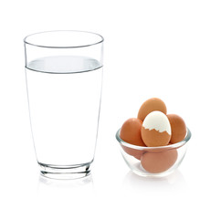 glass of water and boiled egg isolated on white
