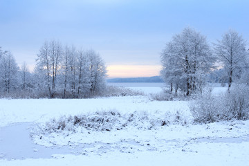 Winter snowy landscape with a frozen lake