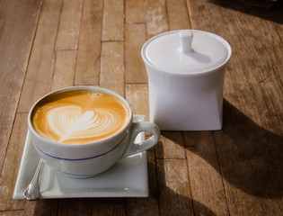 cup of cappucchino over wooden table