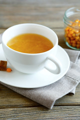 Sea-buckthorn tea in a cup on the linean napkin