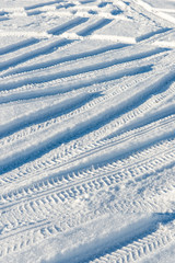 snowy winter road with tire markings