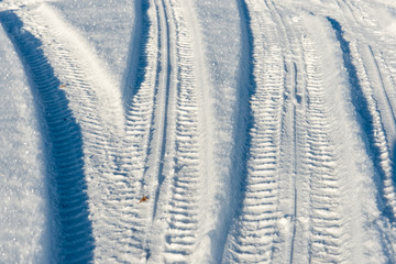 snowy winter road with tire markings