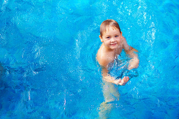 young boy kid swimming in pool