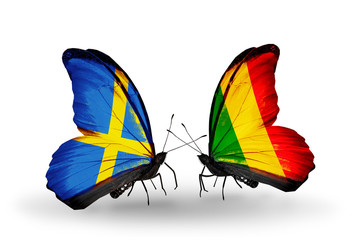 Fototapeta na wymiar Two butterflies with flags Sweden and Mali